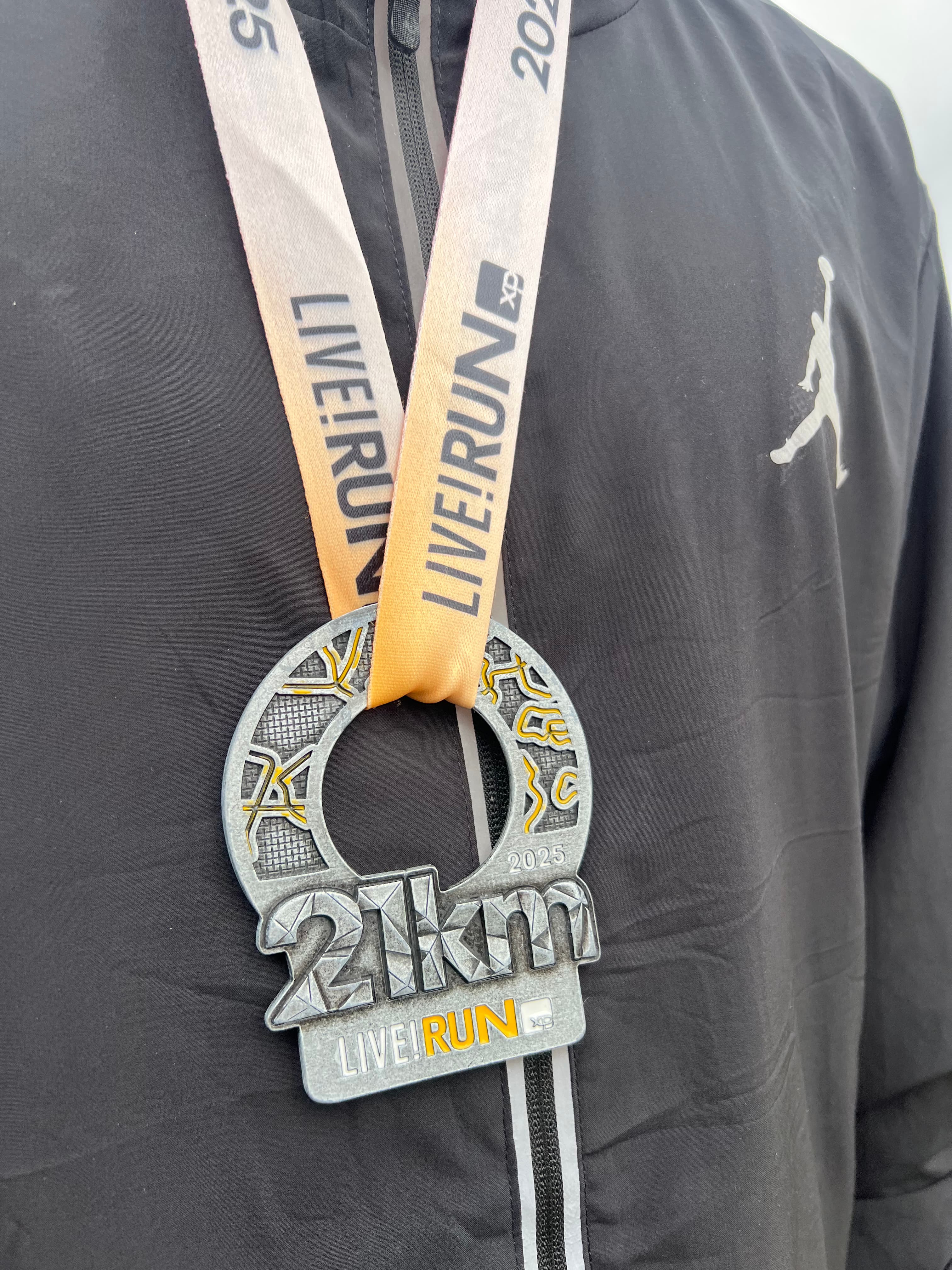 Arthur wearing his first half-marathon medal
