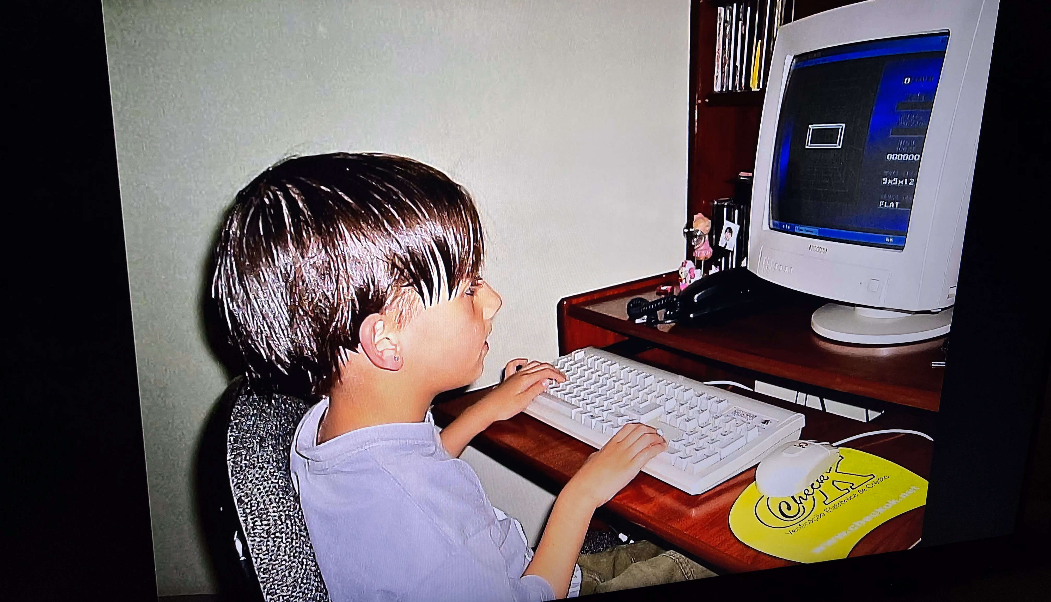 Arthur using a computer as a child